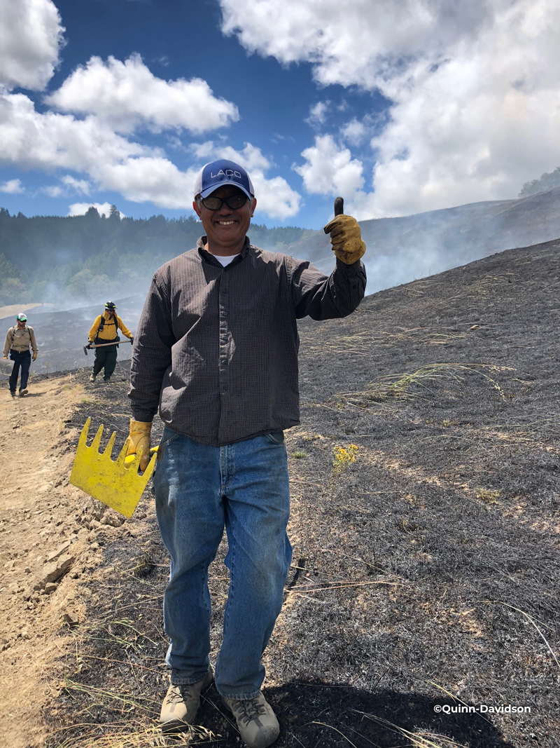 Man giving thumbs up during a prescribed burn
